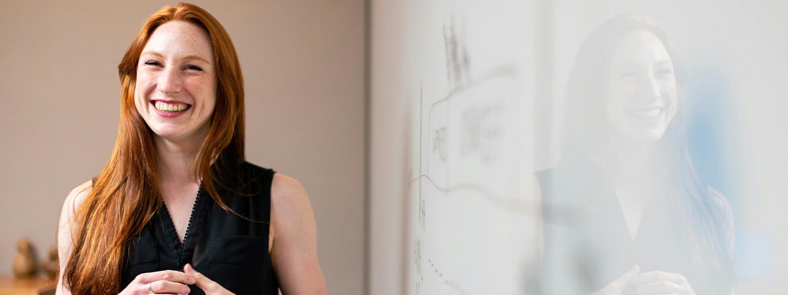 female educator standing in front of a whiteboard